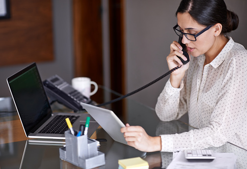 woman answering phone at Rai Oral Surgery & Dental Implants 